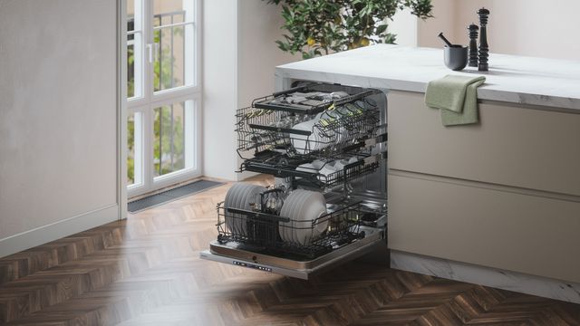 Front view of an opened ASKO dishwasher in a modern kitchen