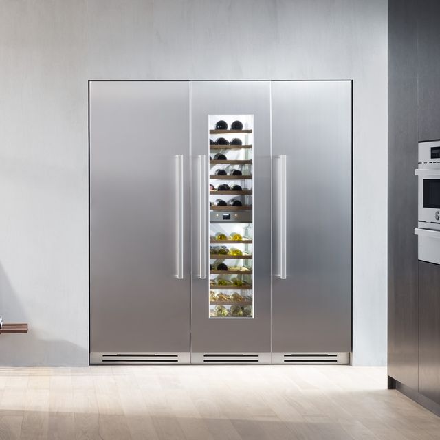 Front view of three Bertazzoni refrigerators built into a modern kitchen.
