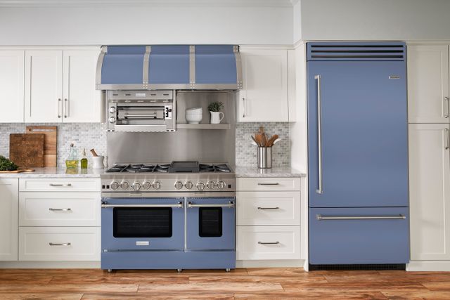 Front view of a modern kitchen with white cabinetry and light blue Bluestar appliances