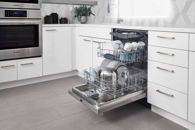 Front view of an opened Bosch dishwasher in a modern kitchen