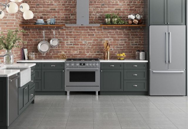 Front view of a rustic kitchen with a brick wall and a 36" Bosch Range
