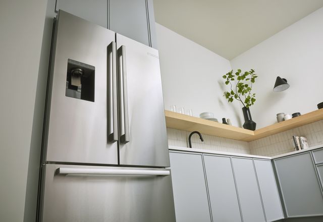 Front low view of a Bosch french door refrigerator in a modern all white kitchen