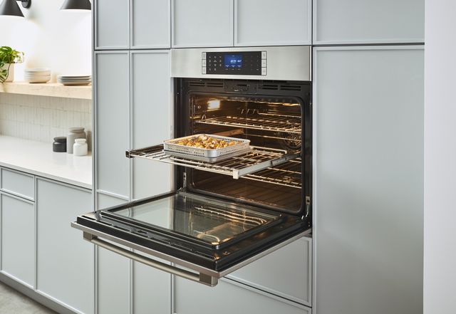 Credit: Bosch Front view of an opened Bosch wall oven in a modern kitchen