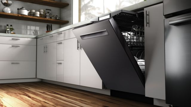 Low view of a black stainless steel Bosch dishwasher slightly opened and full of clean dishes in a modern kitchen.