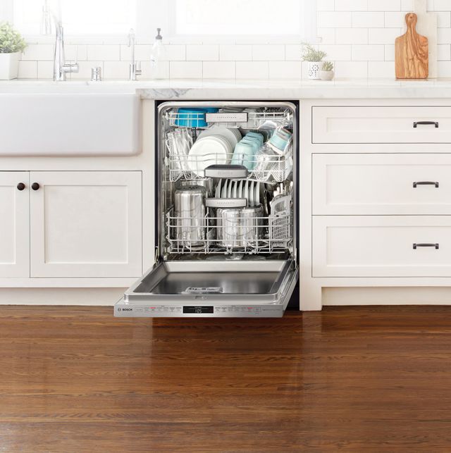 Front view of an opened Bosch dishwasher in a modern kitchen