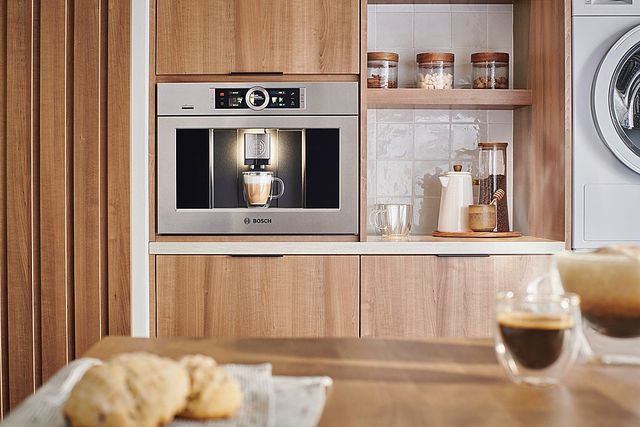 front view of a kitchen coffee bar with a built in coffee maker and coffee ingredients