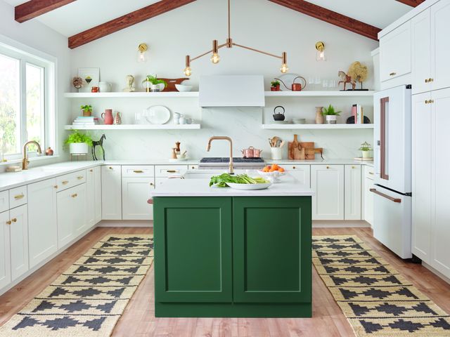 Front view of a modern kitchen with white walls, gold fixtures, and Cafe kitchen appliances