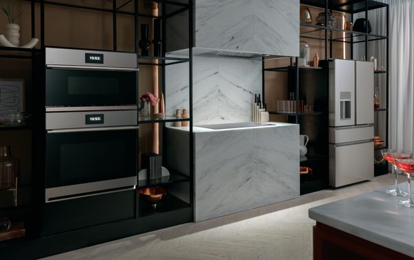 Pieces from the Cafe Glass collection are shown in a modern, luxury kitchen