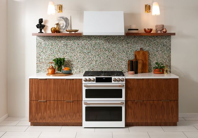 front view of a white and gold cade range in a modern kitchen
