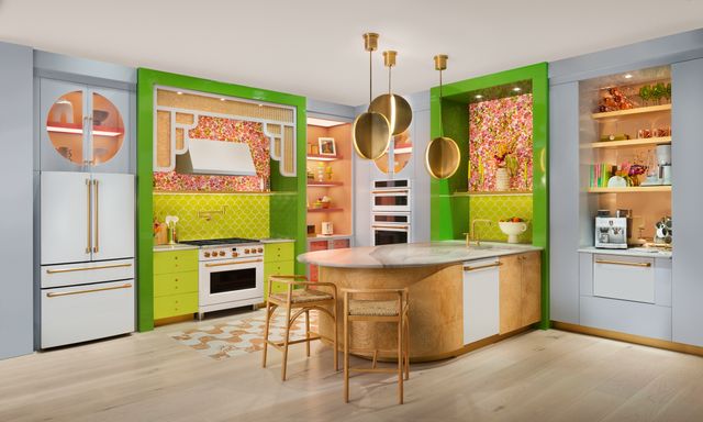 front view of a modern eclectic kitchen with bright color and white and gold cafe kitchen appliances