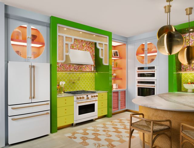 Front view of a bright eclectic kitchen with white Cafe appliances