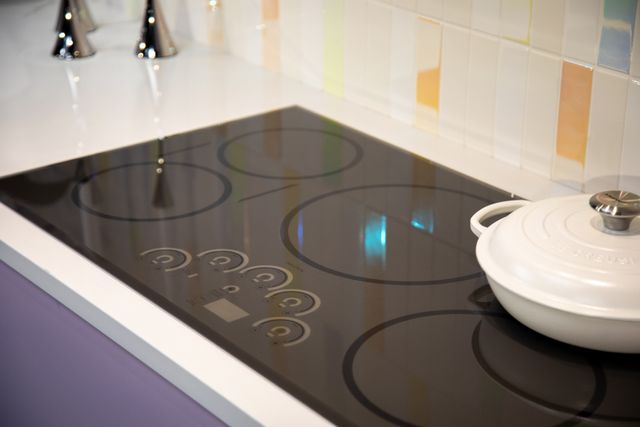 Close view of a black electric cooktop in a modern kitchen