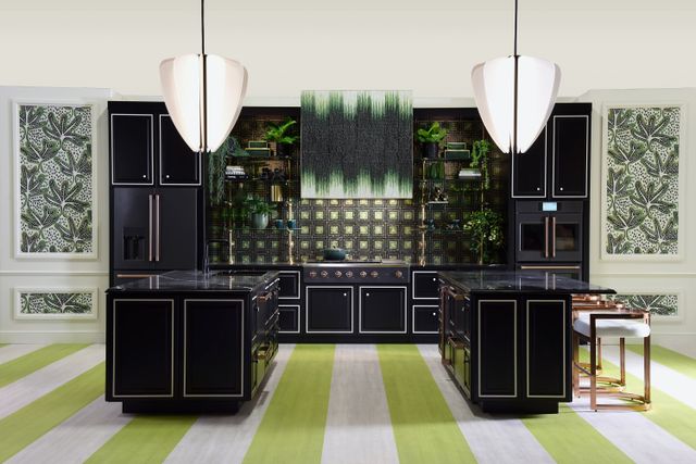 Front view of a luxury kitchen with black cabinetry, countertops, and appliances