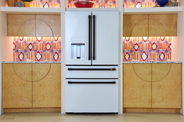 Front view of a kitchen with a white Cafe counter depth refrigerator