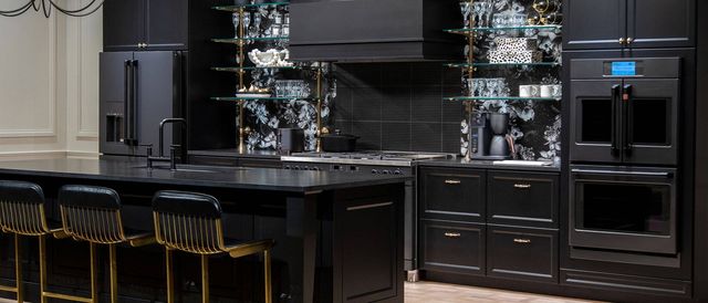 Front view of a modern kitchen with black appliances and cabinetry.