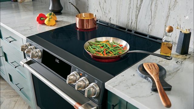 nearby view of a Cafe induction range with a pan of green beans cooking on top