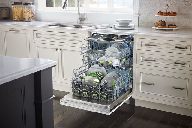 front view of an opened cove dishwasher with the drawers pulled out