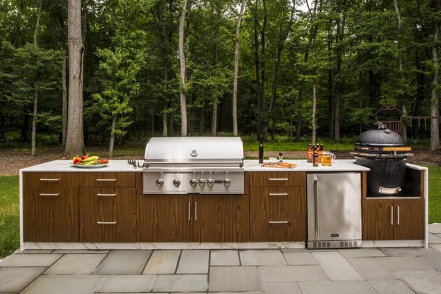 front view of a modern outdoor cooking station with Coyote stainless steel appliances