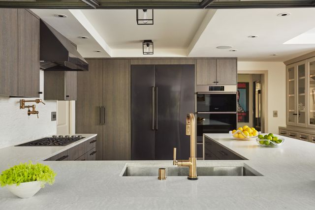 front view of a contemporary kitchen with an island in front of two dacor column refrigerators