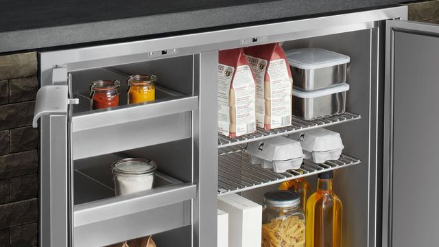 close view of a DCS outdoor undercounter refrigerator with drinks and ingredients inside