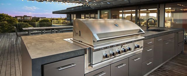 front view of a built in DCS grill in a modern outdoor space