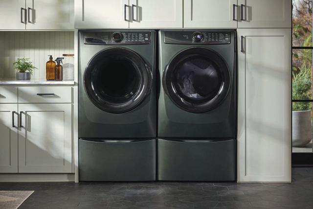 Front view of a modern laundry room with an Electrolux alpine green washer and dryer