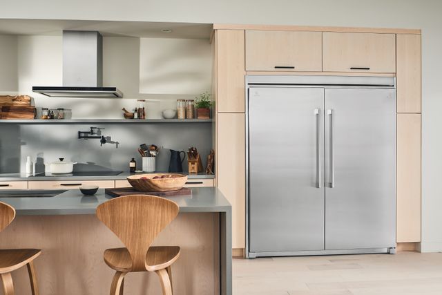 Front view of a modern kitchen with a large Electrolux stainless steel refrigerator