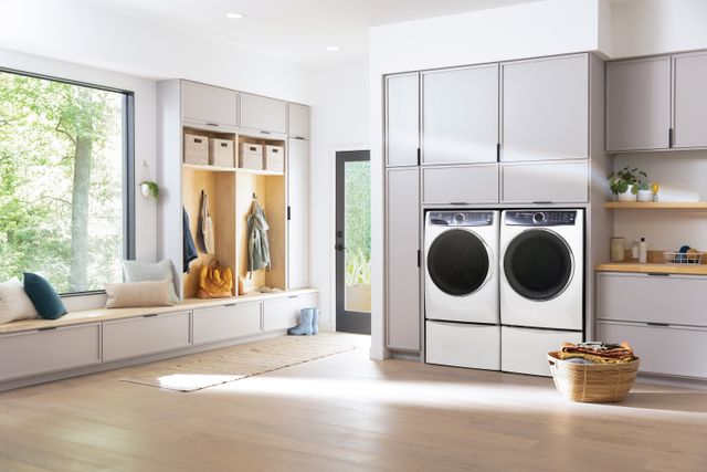 front view of a large white laundry room with a white electrolux washer and dryer
