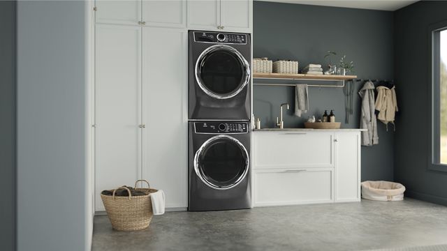 front view of a stackable Electrolux washer and dryer in a modern laundry room