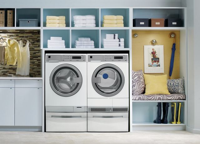 front view of a white Electrolux washer and dryer in a modern laundry room