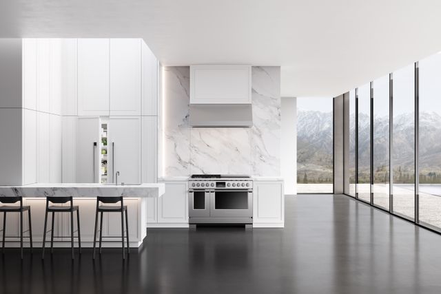 Front view of a luxury kitchen with a panel ready Fisher and Paykel refrigerator and other appliances