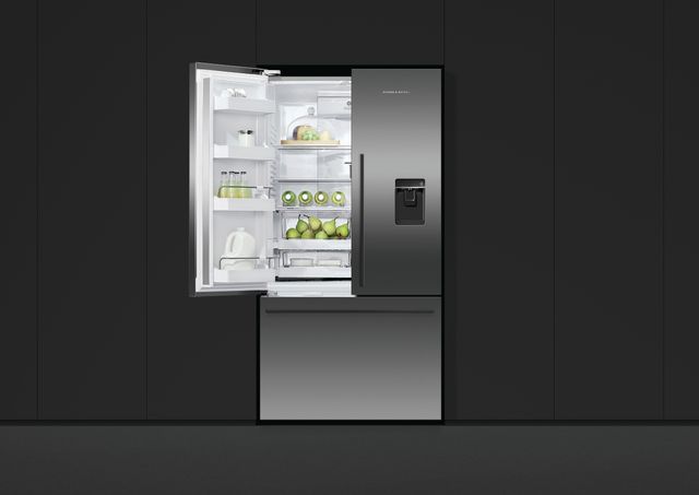 front view of a fisher and paykel bottom freezer refrigerator built into a black panel wall