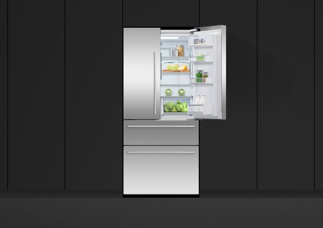 front view of a stainless steel french door refrigerator with the right door open, built into a black wall of cabinetry