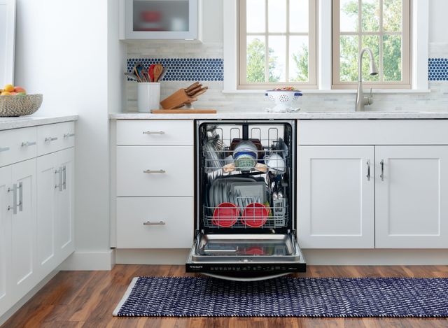 front view of an opened built in dishwasher full of clean dishwasher