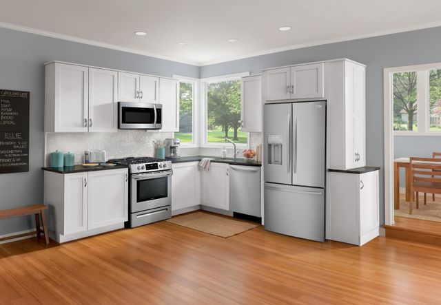 Front view of a modern kitchen with a counter depth stainless steel french door Frigidaire refrigerator