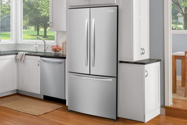 Front view of a modern kitchen with a stainless steel Frigidaire french door refrigerator