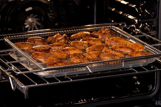 Front view of a pan of wings air frying in a Frigidaire Professional oven
