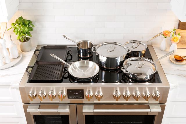 front view of a Fulgor Milano 48" induction range with pans cooking on top