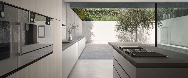 side view of gaggenau wall ovens built into a sleek modern kitchen