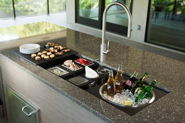 front view of a workstation sink being used a serving station for appetizers and drinks
