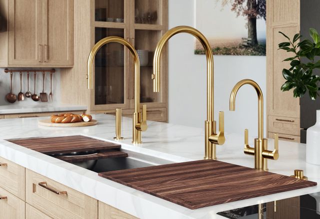 Front view of a Galley kitchen sink with gold faucets
