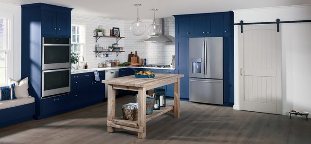 front view of a modern kitchen with a ge profile stainless steel refrigerator