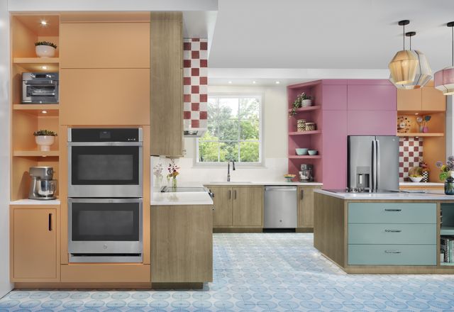 Front view of a colorful kitchen with a GE double wall oven