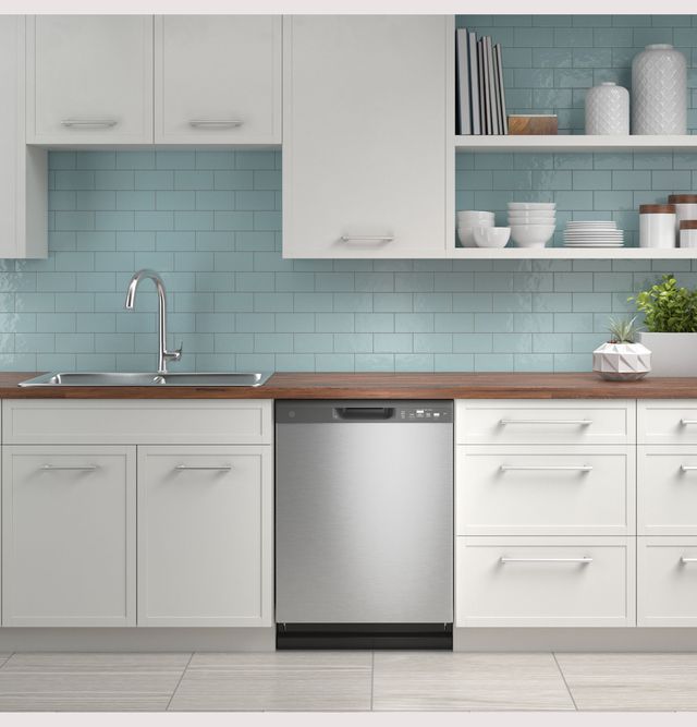 front view of a stainless steel ge dishwasher built into white cabinetry