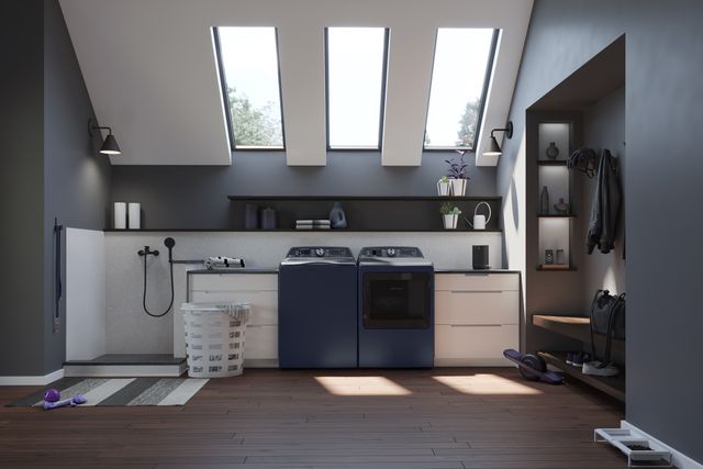 Front view of a modern laundry room with a blue GE washer and dryer.