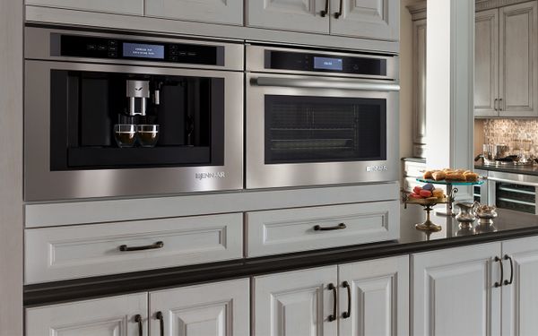 Two JennAir ovens installed side by side in a high end kitchen