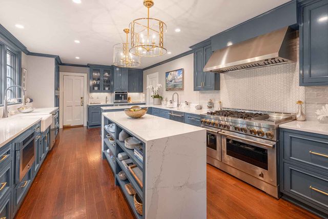 Front view of a modern kitchen with a 48" JennAir range