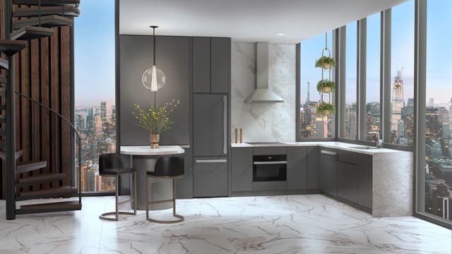 front view of a contemporary kitchen with grey cabinets and a panel ready bottom freezer refrigerator 