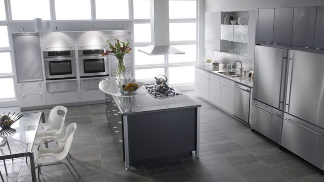 view of a large modern kitchen with stainless steel JennAir appliances including two wall ovens, a dishwasher, cooktop, and refrigerator