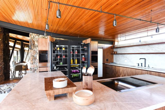 Front view of a modern kitchen with an opened JennAir refrigerator